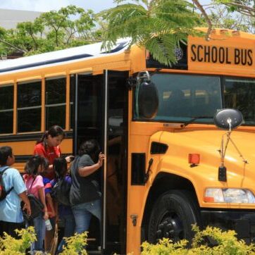 Saipan,,Cnmi—students,And,Their,Chaperones,Board,A,School,Bus,At